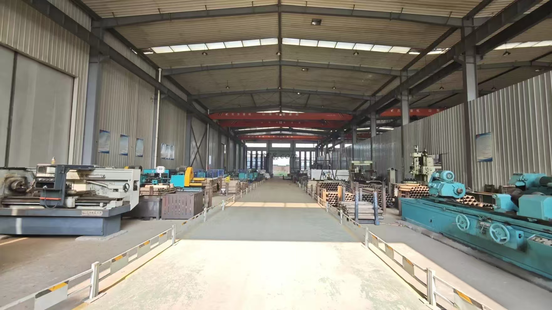 Machining workshop with heavy-duty lathes and cranes